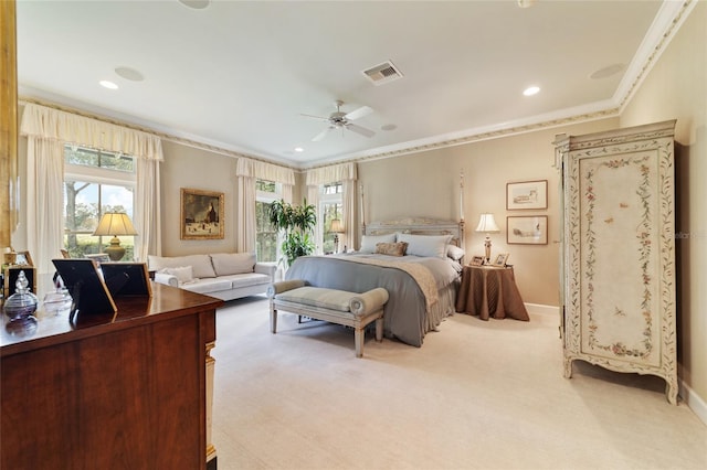 bedroom with ornamental molding, light colored carpet, and ceiling fan