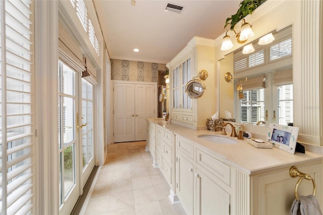 bathroom featuring vanity, crown molding, tile patterned flooring, and a wealth of natural light