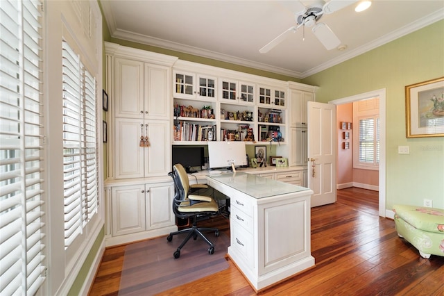 home office featuring built in desk, hardwood / wood-style floors, crown molding, and ceiling fan