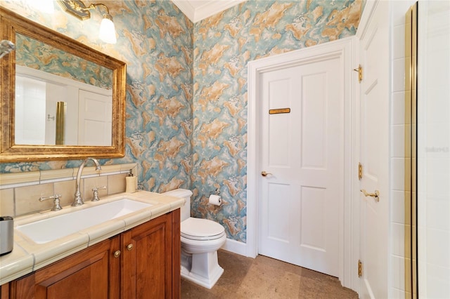 bathroom with a shower with door, vanity, ornamental molding, and toilet