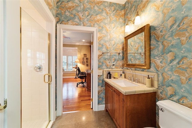 bathroom featuring vanity, a shower with shower door, wood-type flooring, and toilet