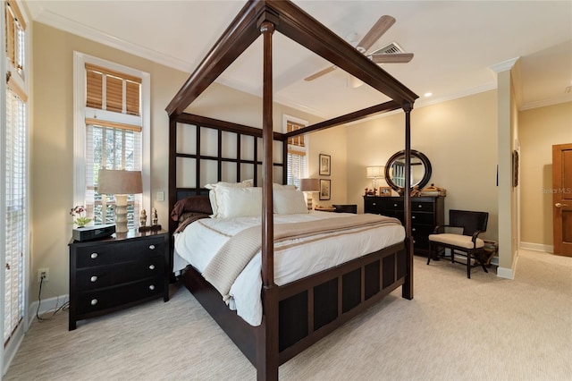 carpeted bedroom with crown molding and ceiling fan