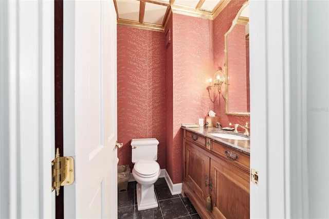 bathroom with toilet, vanity, and tile patterned floors