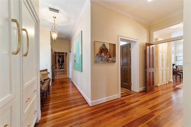 corridor featuring crown molding and hardwood / wood-style flooring