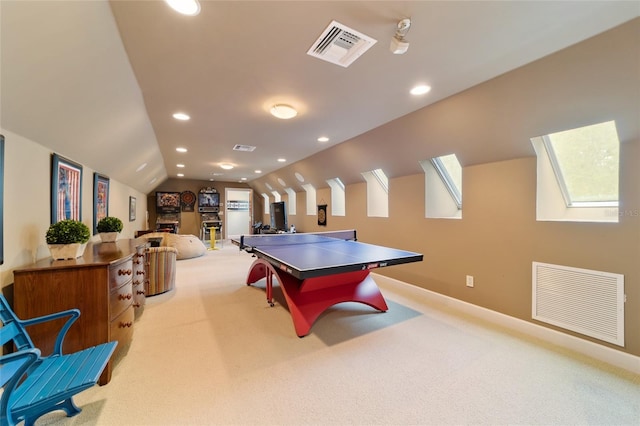 playroom featuring vaulted ceiling with skylight and light carpet