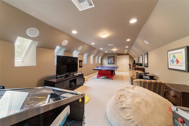 game room featuring vaulted ceiling with skylight and carpet flooring