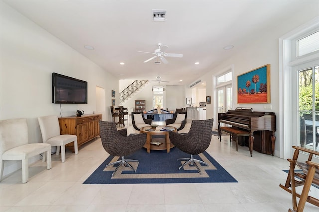 tiled living room with ceiling fan