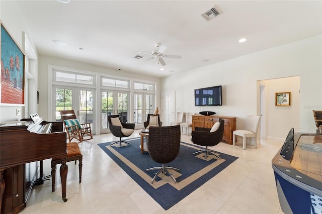 living room featuring french doors, light tile patterned flooring, and ceiling fan