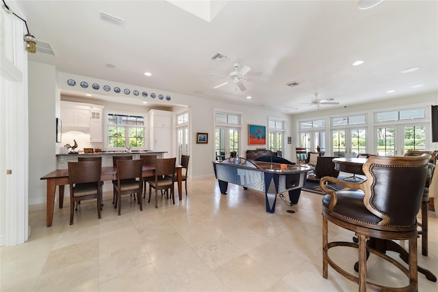 playroom featuring french doors, ceiling fan, and light tile patterned floors