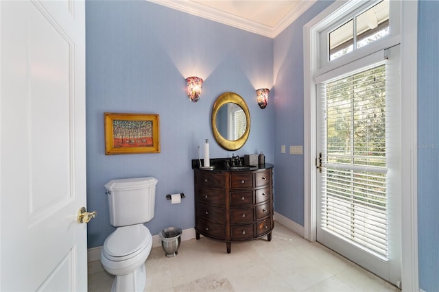 bathroom with vanity, toilet, and crown molding