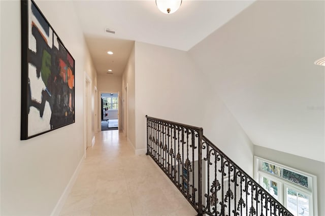 hall featuring light tile patterned floors