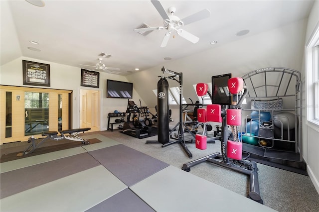 workout room featuring ceiling fan and vaulted ceiling