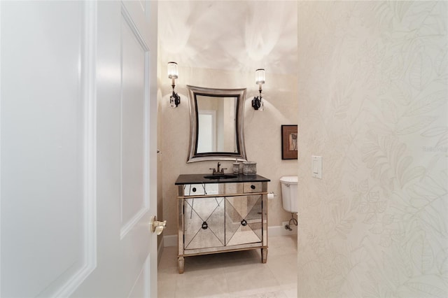 bathroom featuring vanity, toilet, and tile patterned floors