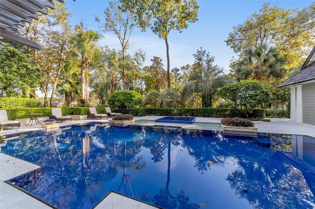 view of pool with an in ground hot tub and a patio