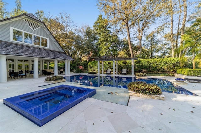 view of swimming pool featuring a patio and a hot tub