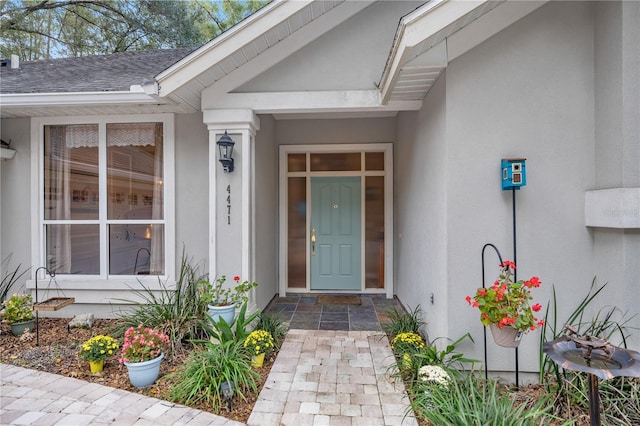 view of exterior entry featuring stucco siding