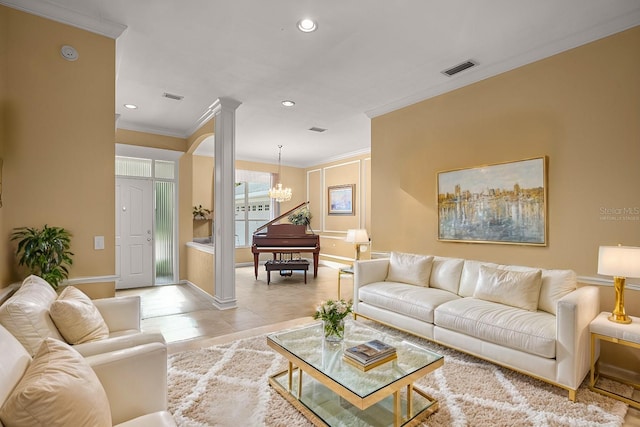 living room with a chandelier, visible vents, crown molding, and ornate columns