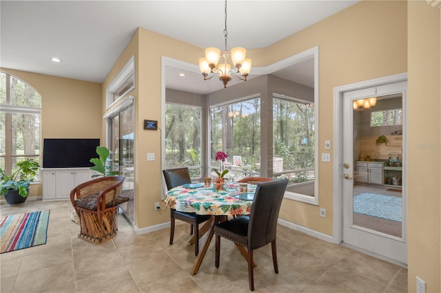 dining space featuring tile patterned flooring, an inviting chandelier, recessed lighting, and baseboards