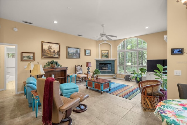 living room with tile patterned flooring, visible vents, a tiled fireplace, recessed lighting, and a ceiling fan