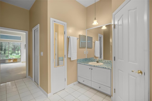 bathroom featuring baseboards, vanity, and tile patterned flooring