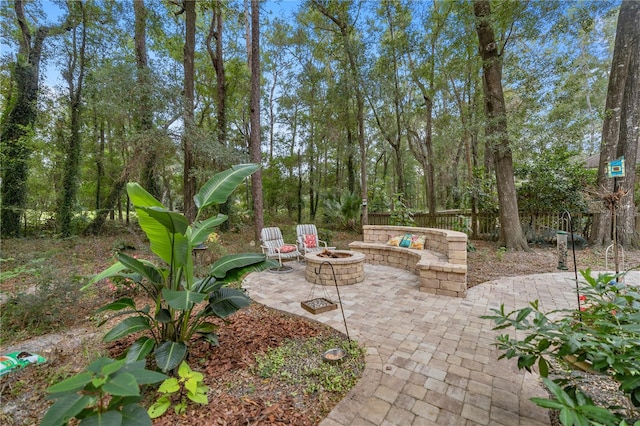 view of patio featuring a fire pit and fence