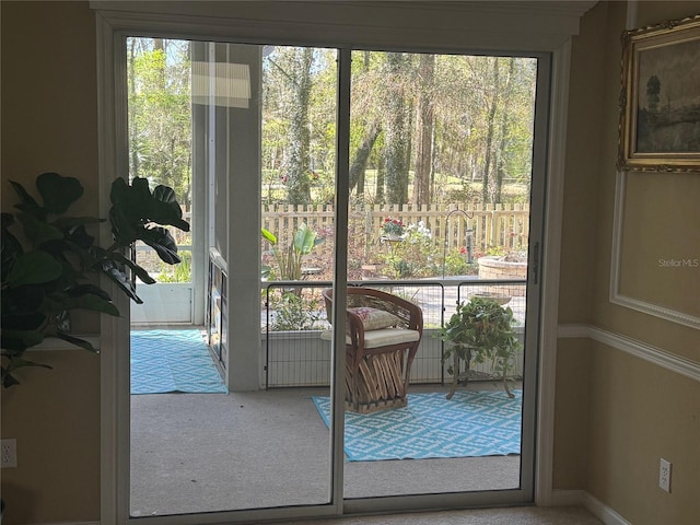 doorway featuring a healthy amount of sunlight and carpet floors