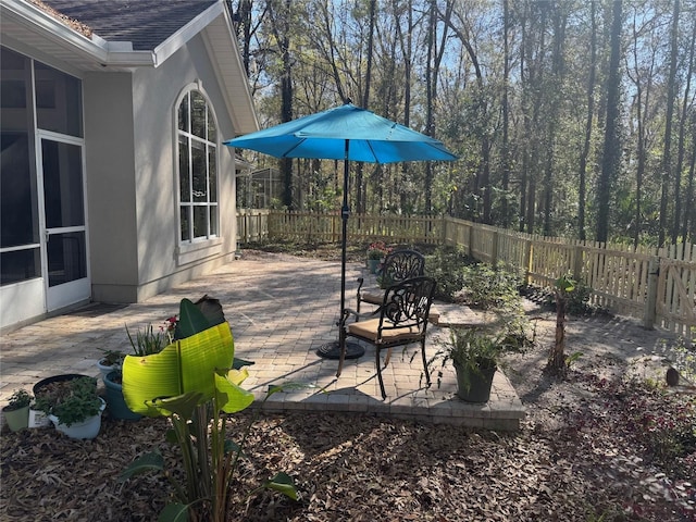 exterior space with a patio, a fenced backyard, and a sunroom