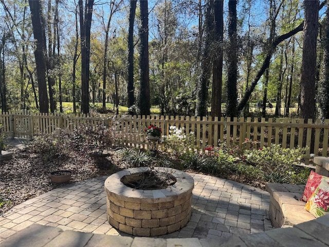 view of patio / terrace with fence and an outdoor fire pit