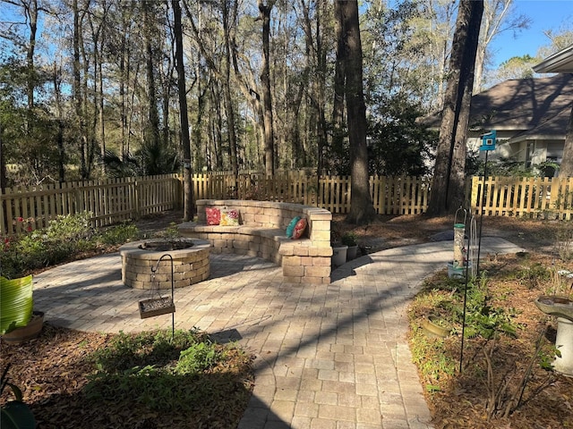 view of patio featuring fence private yard and an outdoor fire pit