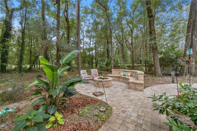 view of patio with a fire pit and fence