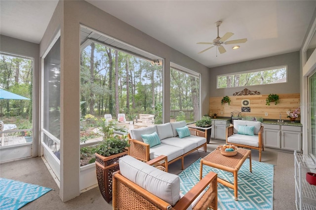 sunroom / solarium with an outdoor hangout area, a ceiling fan, and plenty of natural light