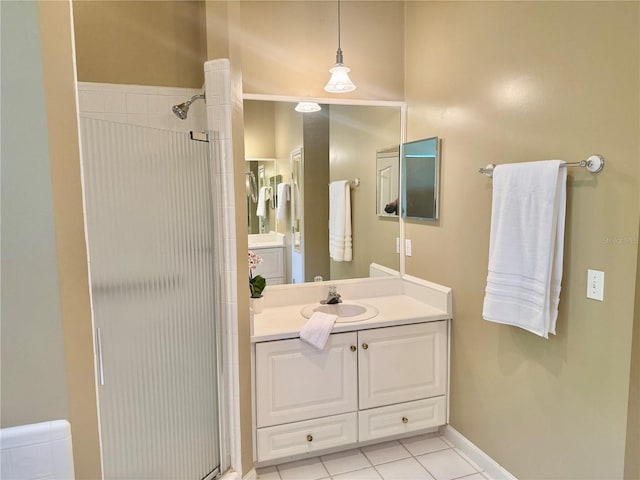 full bathroom featuring tile patterned floors, baseboards, vanity, and a stall shower