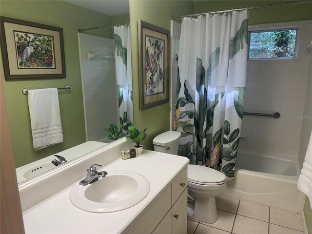 full bath featuring vanity, tile patterned flooring, shower / bathtub combination with curtain, and toilet