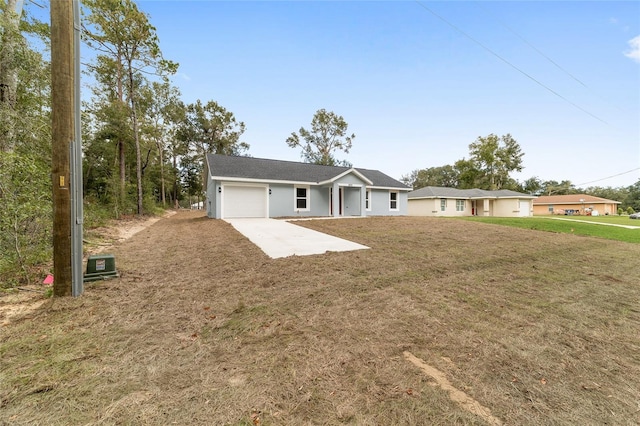 single story home with a garage and a front lawn