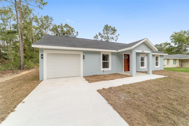 ranch-style home with a front lawn and a garage