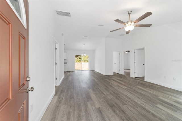 unfurnished living room with a high ceiling, dark hardwood / wood-style flooring, and ceiling fan with notable chandelier