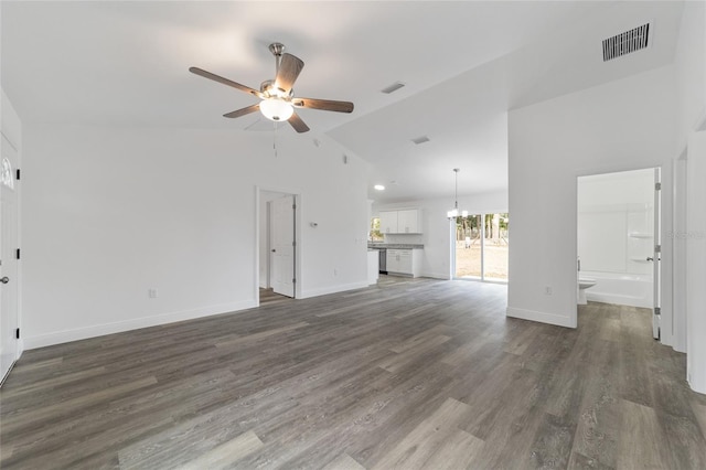 unfurnished living room featuring ceiling fan with notable chandelier, lofted ceiling, and dark hardwood / wood-style floors