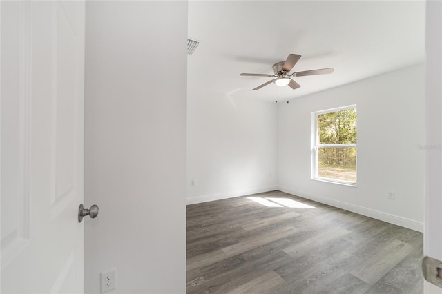 spare room featuring hardwood / wood-style floors and ceiling fan