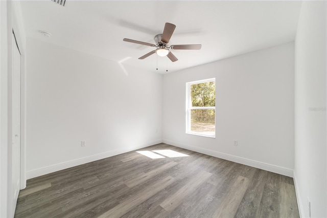 unfurnished room featuring ceiling fan and dark hardwood / wood-style flooring