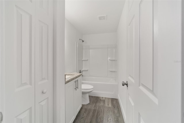 full bathroom featuring vanity, toilet, hardwood / wood-style flooring, and bathing tub / shower combination