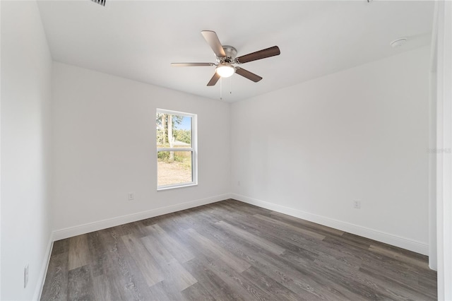 empty room featuring ceiling fan and dark hardwood / wood-style flooring