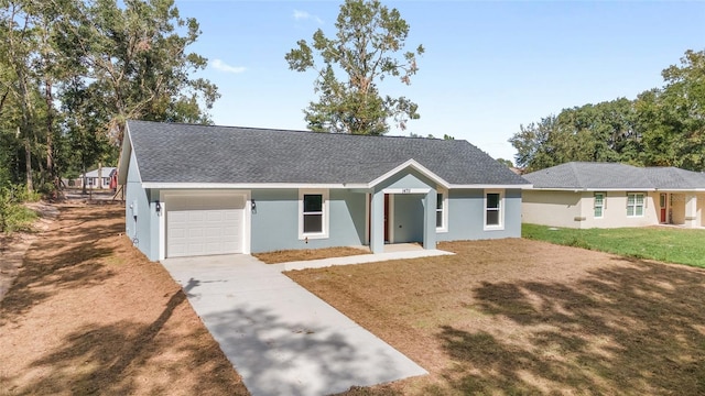 ranch-style home with a front yard and a garage