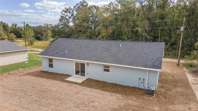 rear view of property featuring central AC unit