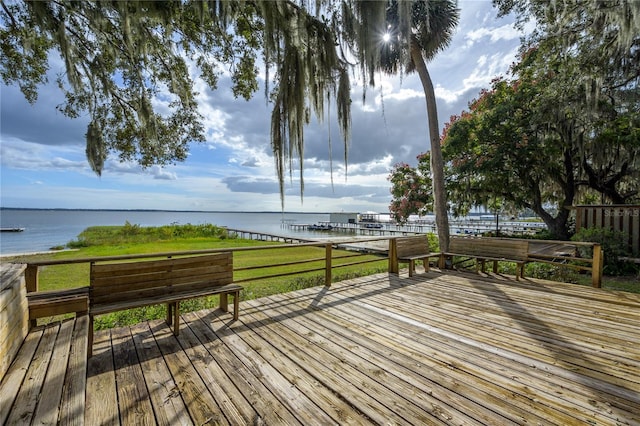 deck featuring a yard and a water view