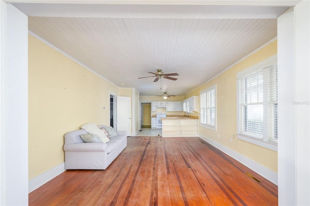 unfurnished living room featuring light hardwood / wood-style floors, crown molding, wood ceiling, and ceiling fan