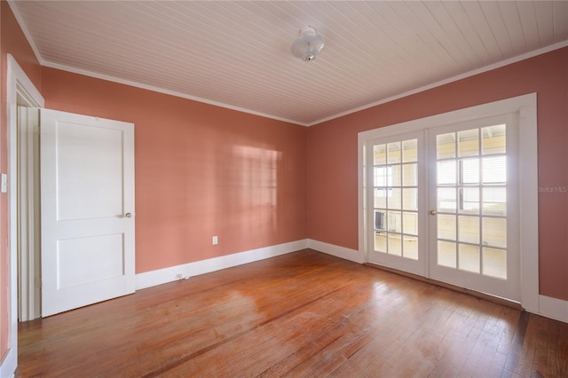 spare room with french doors, crown molding, and hardwood / wood-style floors