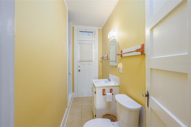 bathroom with vanity, toilet, and tile patterned floors