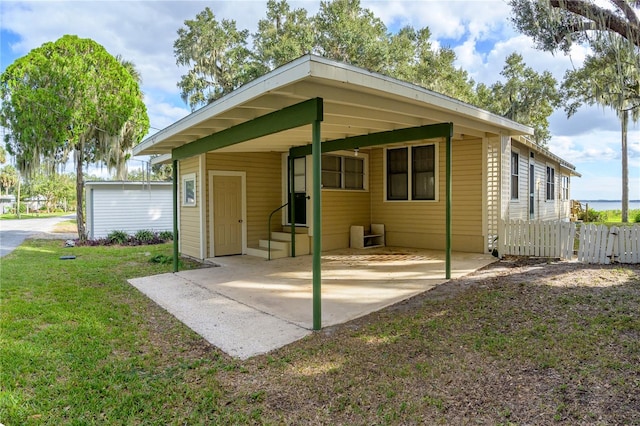 back of house featuring a yard and a carport