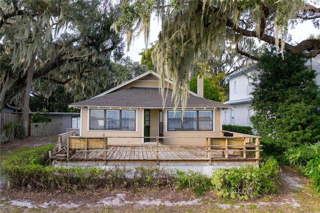 rear view of property with a wooden deck