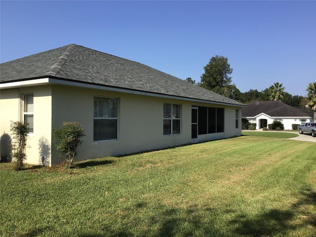 back of property featuring a lawn